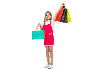 positive teen girl with shopping bag in studio. teen girl with shopping bag on background.