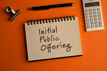 There is notebook with the word Initial Public Offering. It is an eye-catching image.