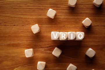 There is wood cubes with the word VRIO. It is an abbreviation for Value, Rarity, Inimitability,...
