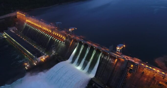 Epic night shots Hydroelectric power plant. Krasnoyarsk hydroelectric power station. Discharge of water at the dam of the power plant. Industrial energy. Yenisei.