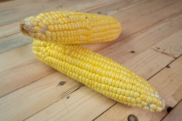 peeled yellow corn on a wooden table