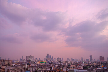 Fototapeta premium The colorful sky over Bangkok city center in the evening. amazing red sky at sunset. Temples and buildings in Bangkok background.