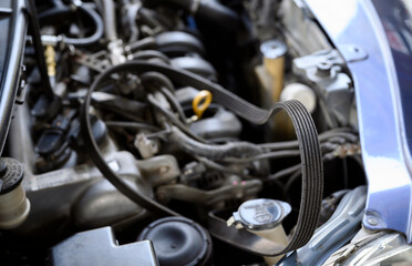 Close-up of broken car serpentine belt.