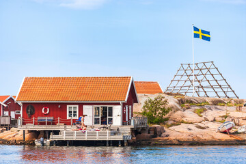 Cottage with people by the sea at the swedish archipelago