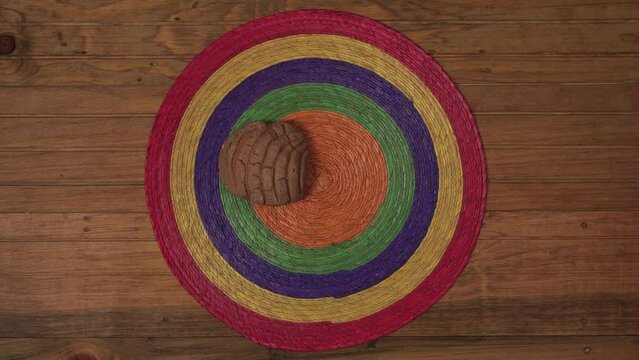 Mexican three Concha Sweet bread Scone Tablecloth and wood Surface putting the bread one by one