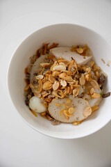 Vietnamese sticky rice flour cake with full topping of fermented meat, eggs and peanuts