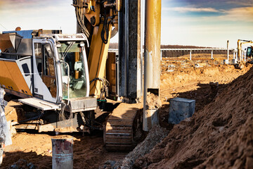 Hydraulic drilling machine in excavation at the construction site. Modern drilling rig. The device...