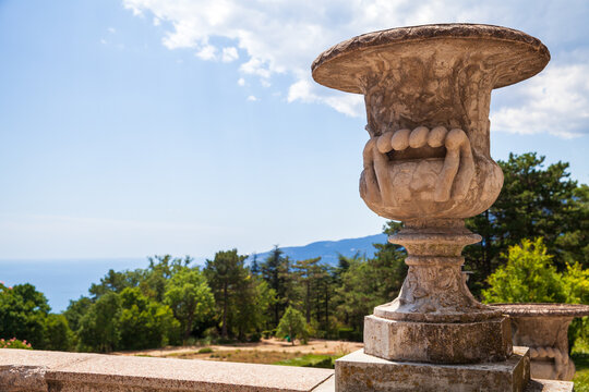 Decorative old stone vase in a garden on a sunny day. Crimea