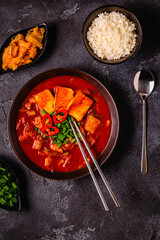 Korean traditional food, spicy kimchi soup (kimchi tige) with pork and tofu cheese.