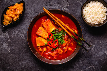 Korean traditional food, spicy kimchi soup (kimchi tige) with pork and tofu cheese.