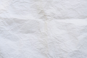 Wrinkled or crumpled white stencil paper or tissue used for background texture
