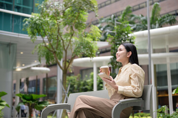 A young businesswoman is working in modern city downtown of Singapore