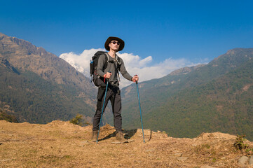 A young traveller trekking on forest trail , Nepal