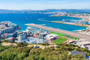 Obraz premium View of runway of the Gibraltar airport and Spanish town La Linea de Conception across the Gibraltar Bay. UK