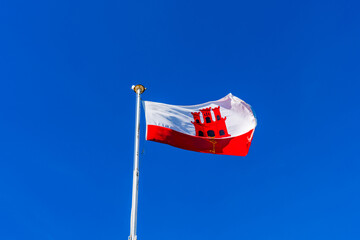 Flag of Gibraltar against blue sky