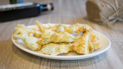 Dish with battered artichokes. Traditional Spanish tapa.