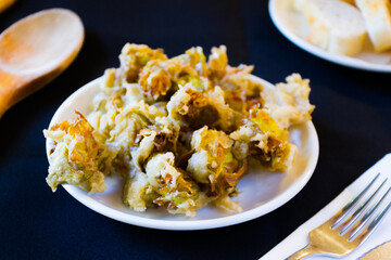 Dish with battered artichokes. Traditional Spanish tapa.