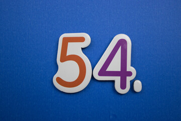 54. number of. Placed on a blue background, photographed from above.