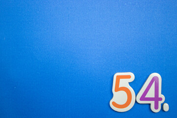 54. number of. Placed on the edge of the blue background, photographed from above.
