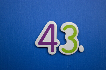 43. number of. Placed on a blue background, photographed from above.