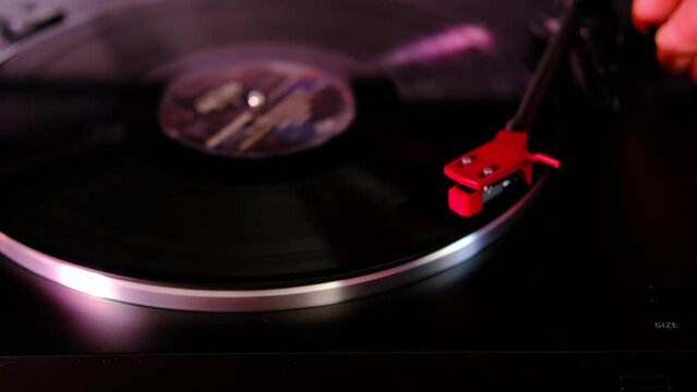close-up of black vinyl record, disk pink floyd is spinning, colored lights, analogue retro music concept, audio experience, relaxation, vintage technology, nostalgia for past, Frankfurt - April 2022