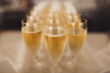 Champagne glasses on a sliver tray.
