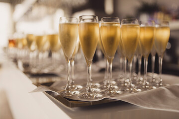 Champagne glasses on a sliver tray.