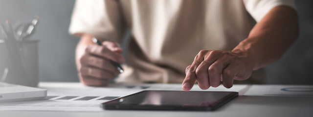 Close up of student hand using tablet. education e-learning concept for banner