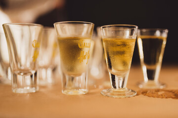 Close up of shot glasses of liquor.