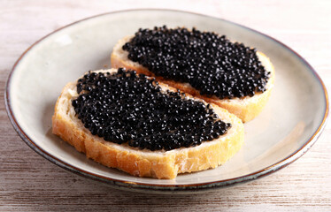 Black caviar over slices of  bread