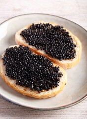 Black caviar over slices of  bread