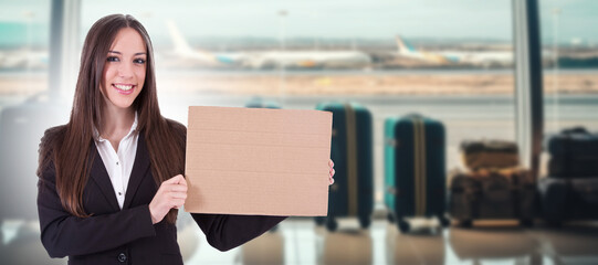 business woman at airport with arrival sign