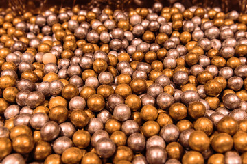 Round dragee. Round chocolate candies close-up. Sweet shop.