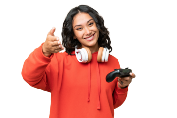Young Argentinian woman playing with a video game controller over isolated background shaking hands for closing a good deal