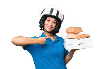 Young Argentinian deliver fast food over isolated background and pointing it