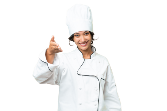 Young chef Argentinian woman over isolated background shaking hands for closing a good deal