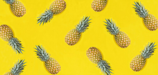 Pineapple on the yellow background. Flat lay. Pattern. Top view.