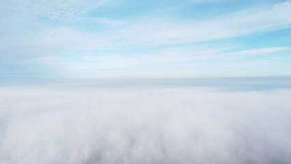 Sky clouds fog. Aerial drone view of blue sky and white clouds. View of fog from above and blue sky with clouds. View from above. Fog movement over city.Abstract natural background. Nature backdrop.