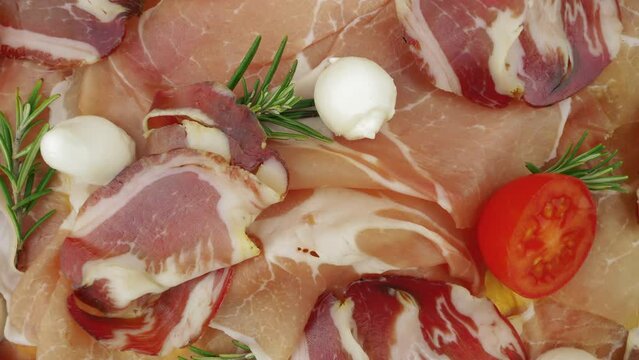 Seasoned and dry-aged ham. Slices of pork dried ham, prosciutto crudo.