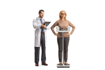 Doctor and a mature woman standing on a weight scale