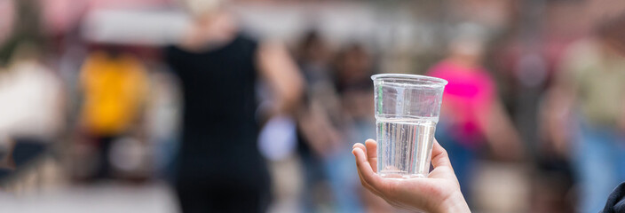 Hand of a man giving a cup of water