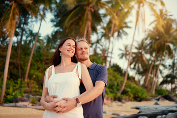 Fototapeta na wymiar Love and romance. Honeymoon on the sea shore. Beautiful loving couple embracing on the tropical beach.