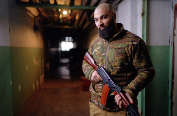 Portrait of the armed man looking with a serious face straight at the camera