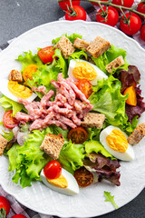 Vosges green salad, egg, bacon salad, crouton, lettuce, salad dressing vinaigrette Lorraine cuisine meal food snack on the table copy space food background rustic top view