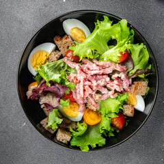 Vosges green salad, egg, bacon salad, crouton, lettuce, salad dressing vinaigrette Lorraine cuisine meal food snack on the table copy space food background rustic top view