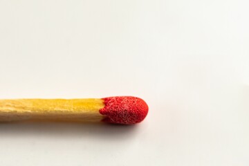 Closeup of a red match head isolated on the white background.