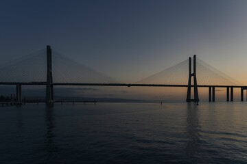 Fototapeta na wymiar Vasco da Gama Bridge at sunrise in Parque das Nacoes, Lisbon, Portugal