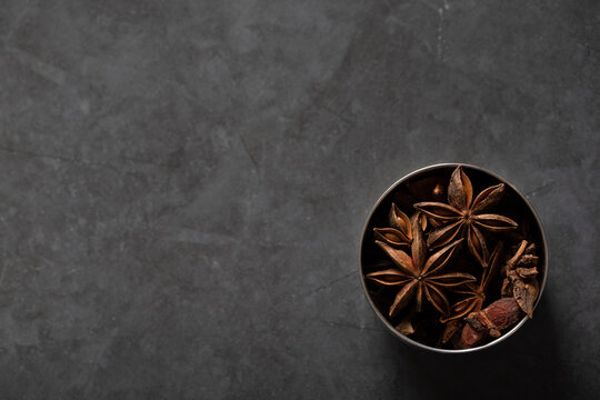 spice tin of star anise on dark marble background
