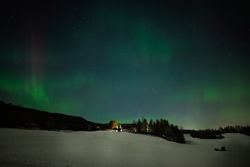 The farm is lit by northern lights