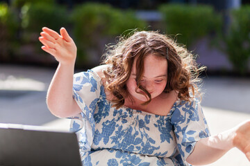 Happy seventeen year old girl with a disability doing a joyful dance move